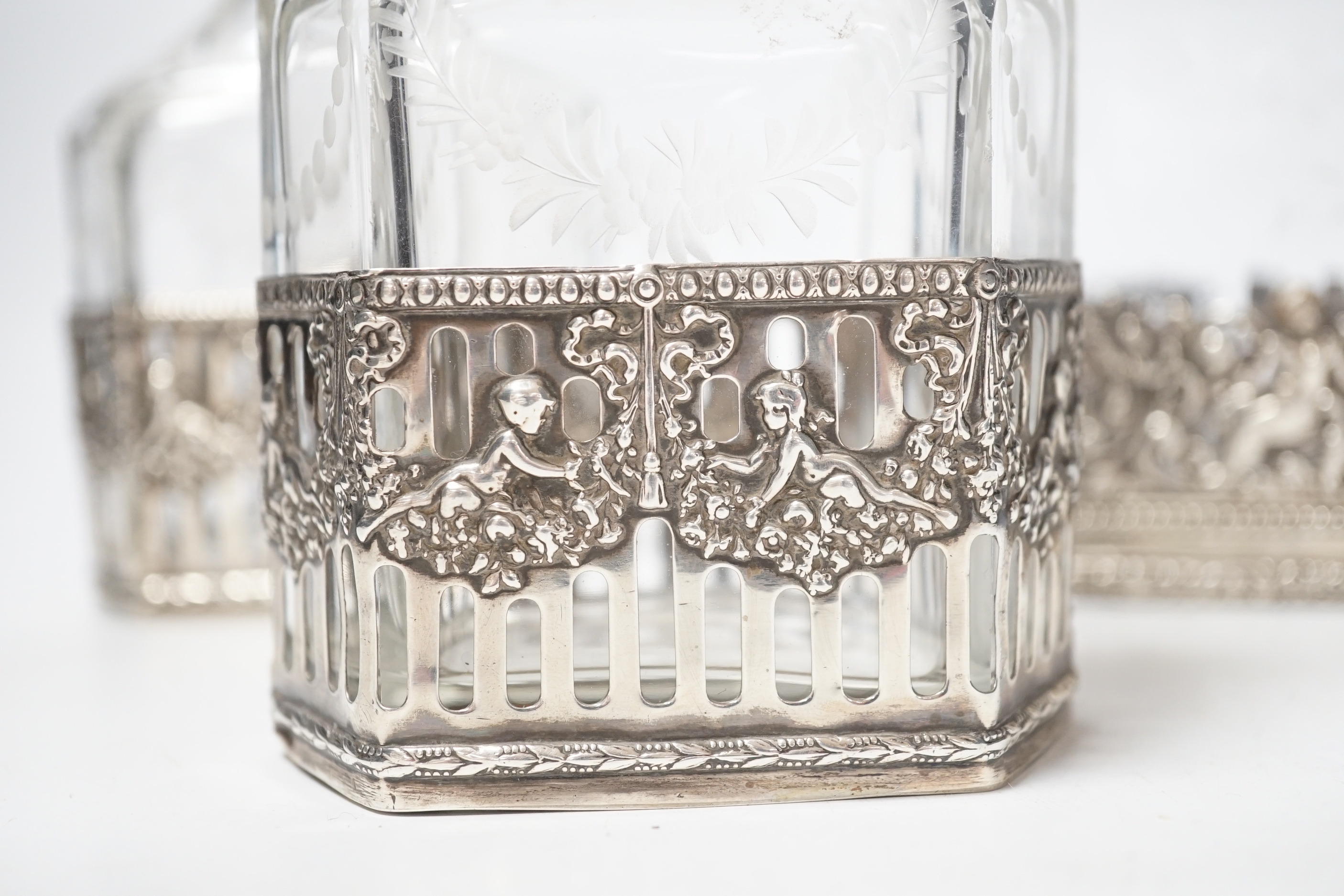 A George V Hanau silver mounted etched glass three piece decanter suite, import marks for Berthold Hermann Muller, London, 1912, tallest 26.5cm (neck broken).